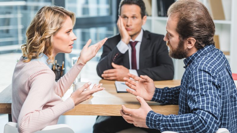 side-view-of-couple-arguing-at-workplace-in-lawyer-office.jpg